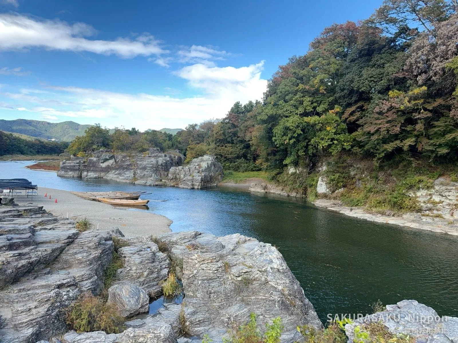 The Iwadatami rock terraces at Nagatoro, with wooden boats drawn up on the shingle and the Arakawa River beyond