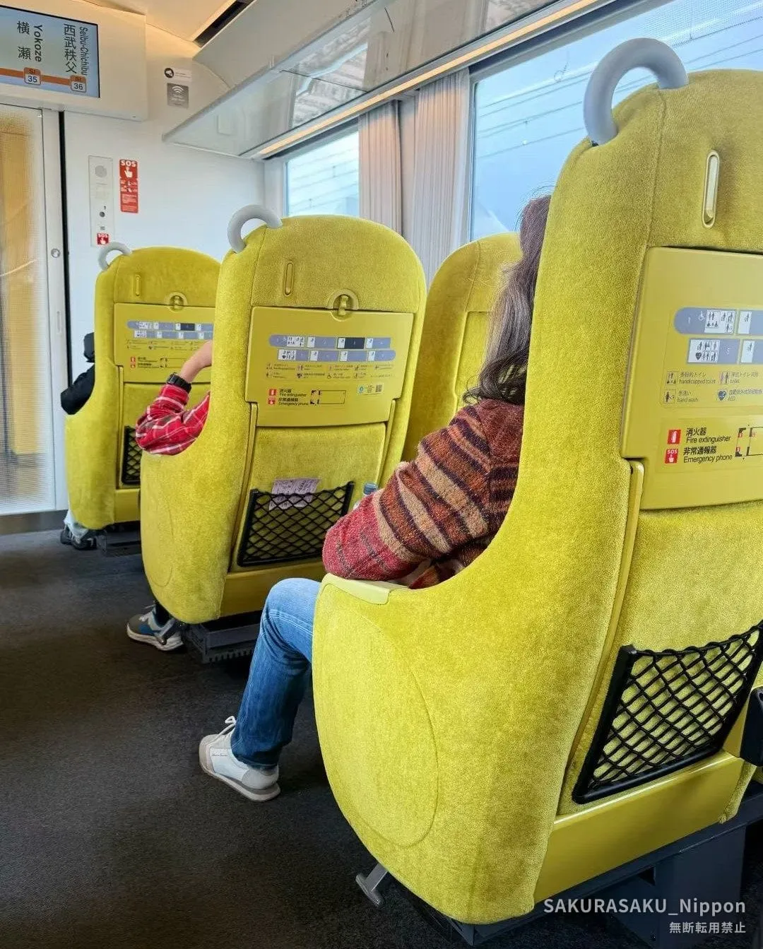 The Laview's yellow seats and big windows, with a display showing Yokoze and Seibu-Chichibu
