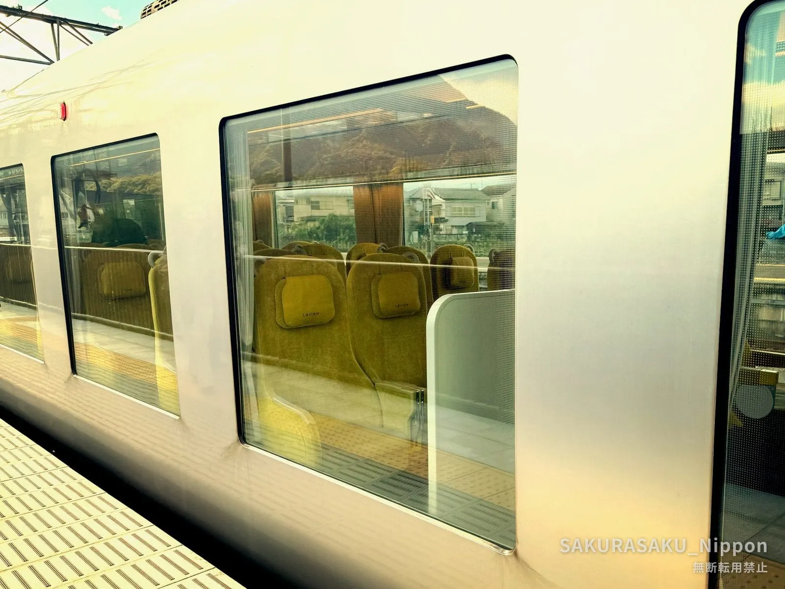 The huge side windows of the Laview, with yellow seats and the view through to the other side